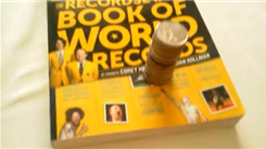 Tallest Tower Of Virginia State Quarters Balanced On A "RecordSetter Book Of World Records"