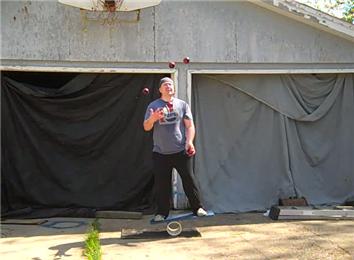 Most Catches While Juggling Five Balls And Balancing On A Rola Bola