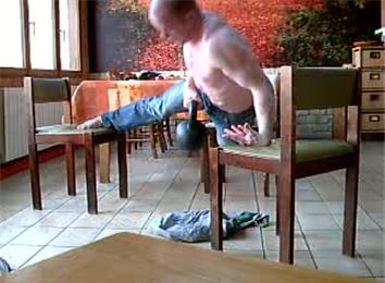 Most Consecutive One-Armed Back-Of-Hand Push-Ups On Three Chairs While Carrying A 20-Kilogram Kettlebell