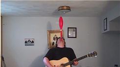 Longest Time To Balance Juggling Club On Chin While Singing And Playing Guitar