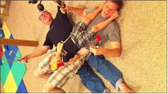 Most Generations Of Family Members Lying On Top Of One Another Holding Kitchen Utensils