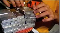 Most Dominoes Balanced On Table Tennis Paddle And Lifted With Hand