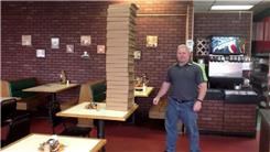 Most Pizza Boxes Held In Hand At Once
