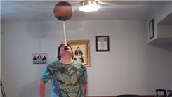 Most Times Circling Basketball Around Waist  While Spinning A Basketball On A Mouthstick Held In Mouth