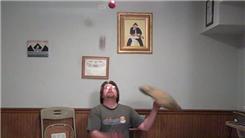 Most Consecutive Catches Juggling Three Balls While Kneeling And Spinning A Pillow On One Finger