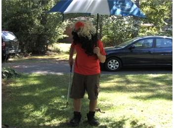 Most Golf Ball Bounces On A Sand Wedge In 30 Seconds While Wearing Two Wigs, Strength Shoes And Holding An Umbrella