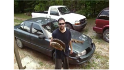 Fastest Time To Run Four Laps Around A Car While Holding A Mounted Bass