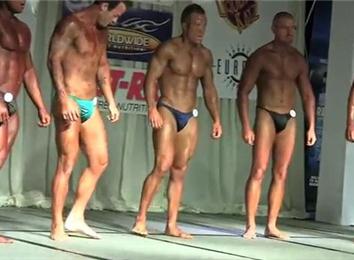 Most Male Body Building Contestants Posing In A Hotel Ballroom At Once