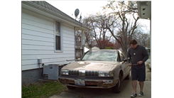 Most Consecutive Laps Around A Four Door Vehicle While Bouncing Two Table Tennis Balls On Two Paddles Simultaneously 