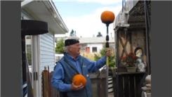 Longest Time To Balance Two Pumpkins On Top Of A Pole On Chin While Sitting