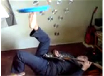 Most Plates Spun On Feet While Playing Electric Guitar