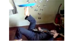 Most Plates Spun On Feet While Playing Electric Guitar
