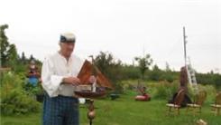 Longest Time To Balance A Bluenose Replica On Chin While Kneeling