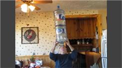Longest Time Balancing Two 5-Gallon Water Bottles On Forehead