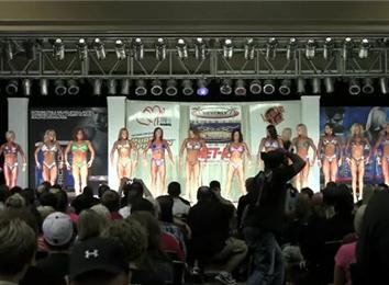 Most Female Body Building Contestants Posing In A Hotel Ballroom