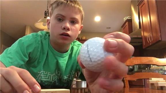 Most Jenga Blocks Stacked on a Golf Ball Held in hand 