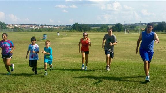 Most Youth Runners and Coaches Completing a One Mile Cross Country Race in Clermont, Florida for Global Running Day