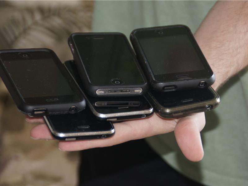 Most iPhones Held In Hand At Once 