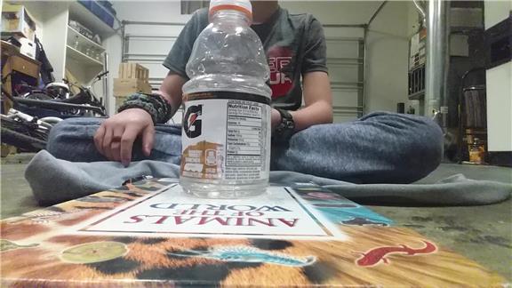 Most Plastic Bottle Flips Onto A Book In One Minute