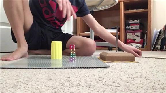 Most Dice Stacked On Nails Using A Dice Cup In One Minute