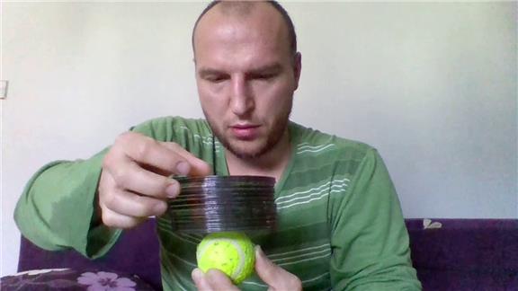 Tallest CD Tower Stacked On A Tennis Ball Held In Hand