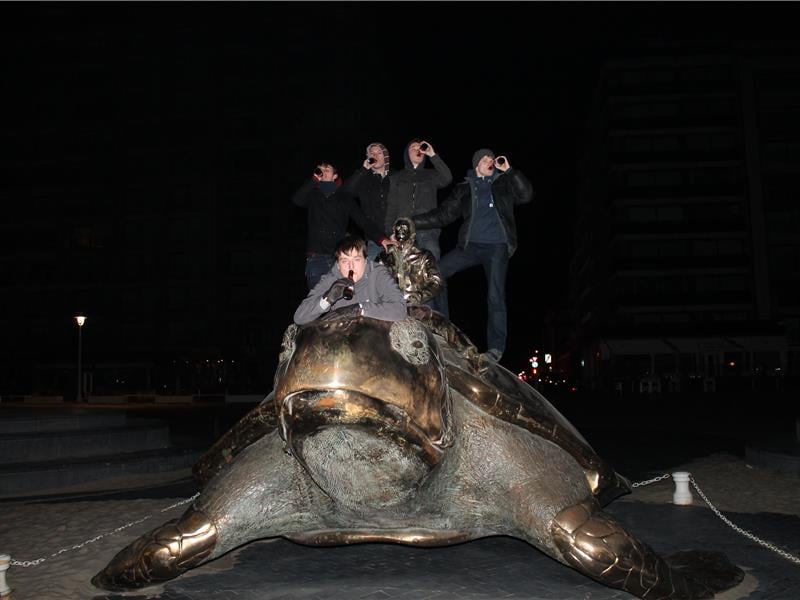 Most People Drinking Beer While Standing On A Giant Turtle Statue