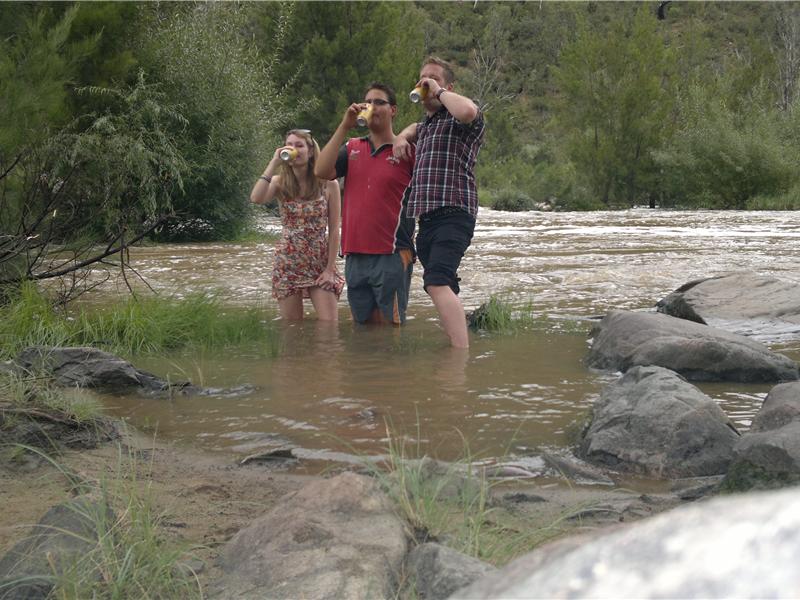 Most People Drinking Beer While Standing In A River